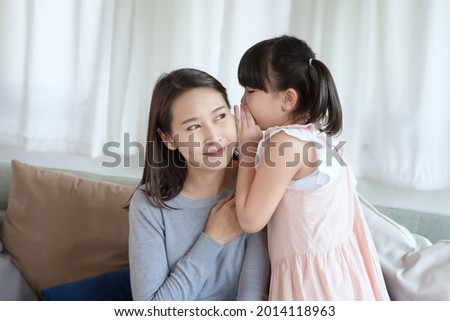 Asian mother feel happiness during playing her cute daughter with love and care at home
