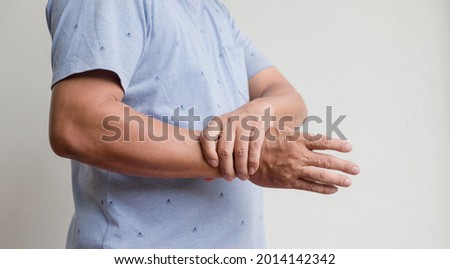 Man hand with numbness and pain in the wrist has pain and tingling in the nerve endings. which is a side effect of Guillain-Barre Syndrome after vaccination against COVID-19.