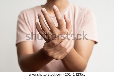 Woman hand with numbness and pain in the palm of the hand has pain and tingling in the nerve endings. which is a side effect of Guillain-Barre Syndrome after vaccination against COVID-19. Royalty-Free Stock Photo #2014142351