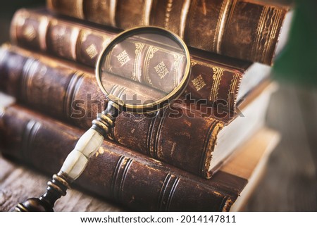 Book and magnifying glass concept for education, knowledge and searching for information