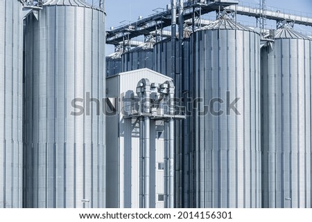 Agricultural Silo - building for storage and drying of grain crops. Industrial concept, silo tower over blue sky