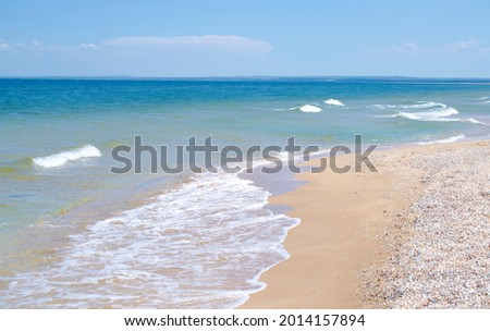 Waves on the sandy seashore are a beautiful summer background. Design of the background, photo wallpapers, covers, screensavers. Royalty-Free Stock Photo #2014157894