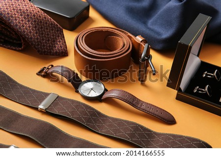 Stylish male accessories on color background Royalty-Free Stock Photo #2014166555
