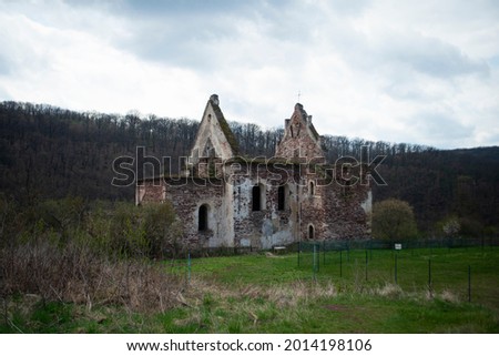 Mysterious mystical ruins of an old Catholic Polish church in Ukraine in Chervonograd, abandoned facades of church buildings Royalty-Free Stock Photo #2014198106