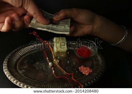 Raksha Bandhan Special plate decorated with rakhi sweet kumkum and brother gifting sister