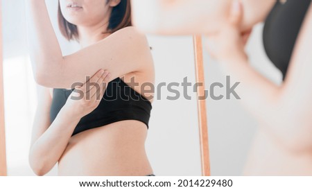 A woman who touches her loose upper arm, diet image Royalty-Free Stock Photo #2014229480