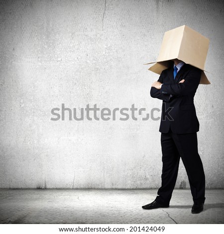 Businessman in suit wearing carton box on head