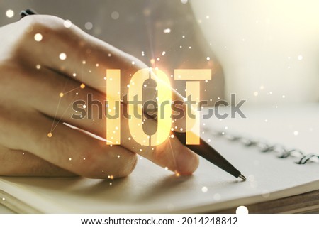 Creative IOT illustration with man hand writing in diary on background, future technology concept. Multiexposure