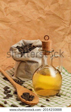 sunflower oil with a bag of seeds and a wooden spoon