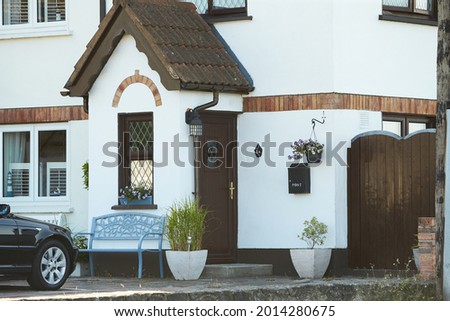 View of brightly Irish house front with traditional colored england entrance door.