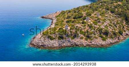 Aerial view of antiquated stone windmills at a cape in Ithaca in Ithaca near the Ionian sea