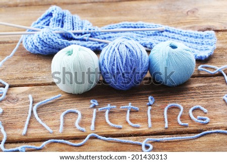 Yarns for knitting on wooden table close-up
