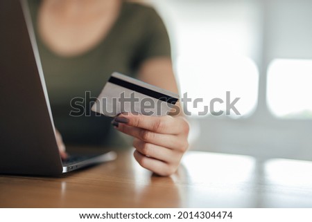 Closeup of a credit card being used to buy something online.