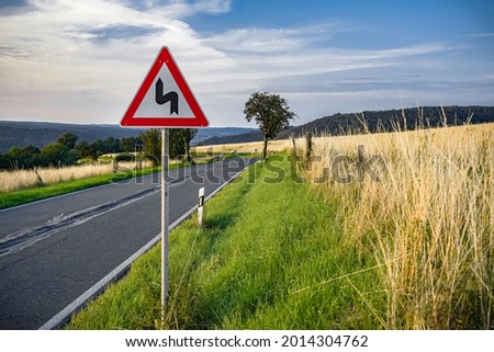 ATTENTION! The sign warns  about the mountain road full of dangerous bends.
