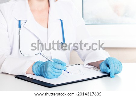 doctor in office studying medical charts, health and Medicine, healthcare concept