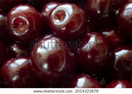 Dark red ripe cherries without peduncle closeup