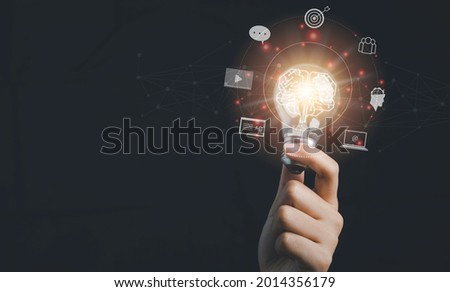 Digital marketing strategy idea concept. Content creator holding a bright light bulb great creative for target with virtual icon. Royalty-Free Stock Photo #2014356179