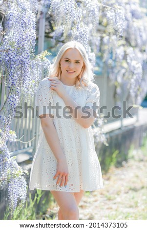 Portrait of a young beautiful woman in a blooming garden. Spring.