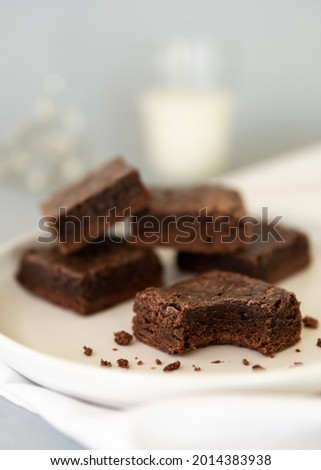 Pieces of brownies with a glass of milk