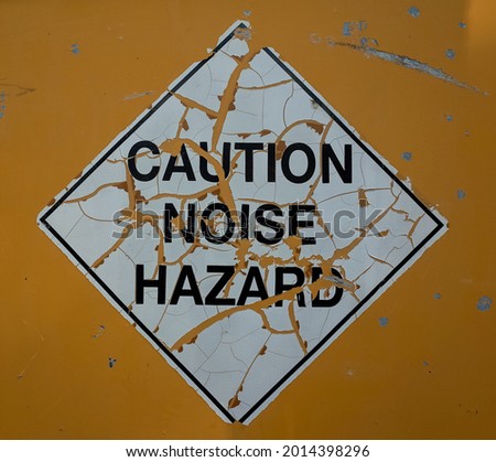 photo of caution sign avoid noise hazard