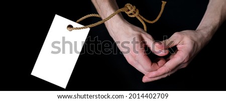 male hands making heart gesture on black background, blank tag on a rope, isolated image, love confession concept, relationship symbol, valentine's day, personality value