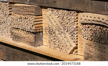 A homemade insect hotel on a wooden shelf