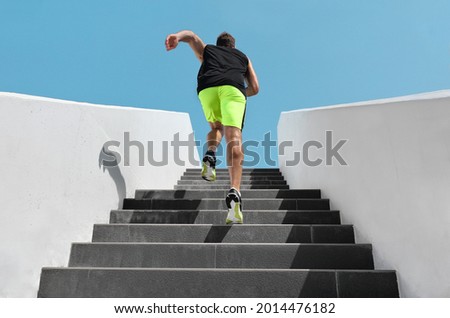 Stairs exercise fitess man running fast up the staircase for hiit cardio workout run at outdoor gym. Sport active athlete lifestyle training legs muscles. Royalty-Free Stock Photo #2014476182