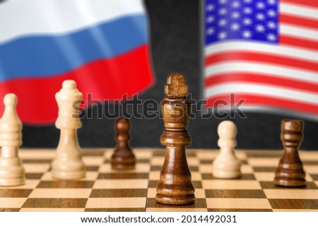 Russia vs USA, chess like geopolitics game. Flags of United States and Russian Federation and chessboard. Royalty-Free Stock Photo #2014492031