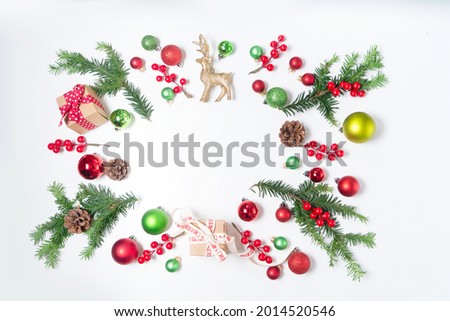 Colorful christmas lifestyle - evergreen twigs with christmas decorations, frame with copy space