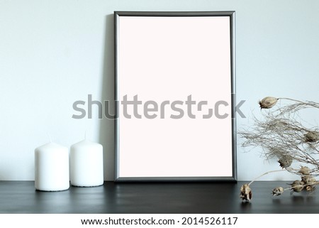 mockup for pictures and arts, blank frame on the table with candles and dry flowers