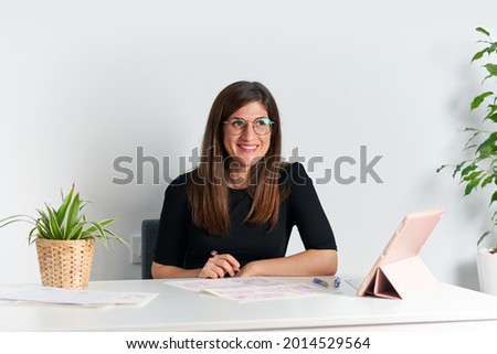 Portrait of a female illustrator at her desk during teleworking day