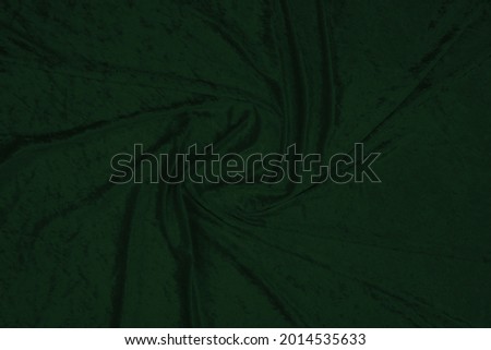 Velours fabric drapery backdrop abstract background. Shapeless empty green surface suitable for creating a cozy, pleasant, soft, warm, winter, autumn, festive, expensive design. Сopy space