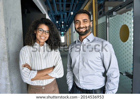 Two happy diverse professional executive business team people African American woman and Indian man looking at camera standing in office lobby hall. Multicultural company managers team portrait. Royalty-Free Stock Photo #2014536953