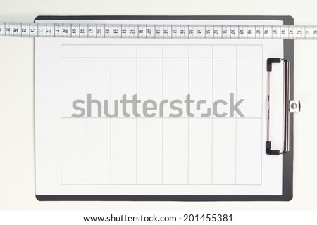 Blank clipboard with measuring tape. Closeup isolated on white, copy space.