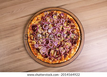 Delicious pizza in close-up on a wooden table.