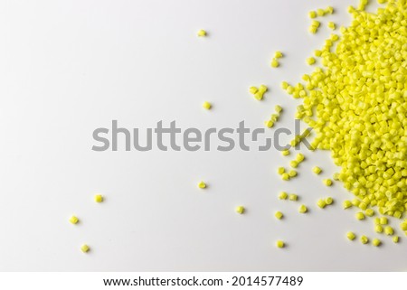 Yellow granules of polypropylene or polyamide on a white background. Plastics and polymers industry. Copy space Royalty-Free Stock Photo #2014577489