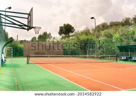 Mini outdoor sports ground, facilities for training and playing football, basketball, volleyball and tennis court. Active recreation in the park on a summer day surrounded by trees Royalty-Free Stock Photo #2014582922
