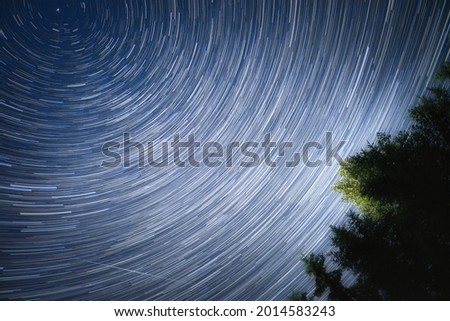 A picture of star trails of the night sky.  