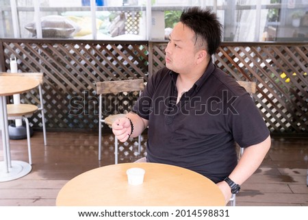 A man talking to a neighbor at a cafe