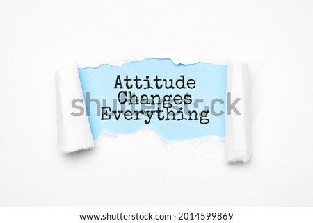 Concept of discovering Attitude Changes Everything. Uncovered unrolled beige torn paper and search engine optimization abbreviation.