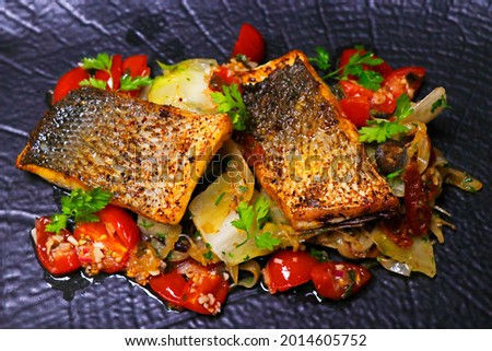 pan fried sea bass fillet with mediterranean style sauteed fennel, chicory and cherry tomato with lemon sauce Royalty-Free Stock Photo #2014605752