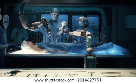 Team of surgeons wearing special augmented reality glasses perform a delicate operation using medical surgical robot arms. Modern medical equipment. Robotic arm for minimal invasive surgery. Royalty-Free Stock Photo #2014627751