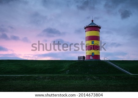 A scenic view of the Pilsum lighthouse in Krummhorn, Germany during sunset Royalty-Free Stock Photo #2014673804