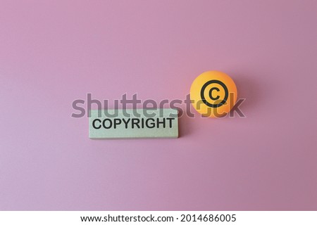 The word copyright and copyright symbol isolated on pink background
