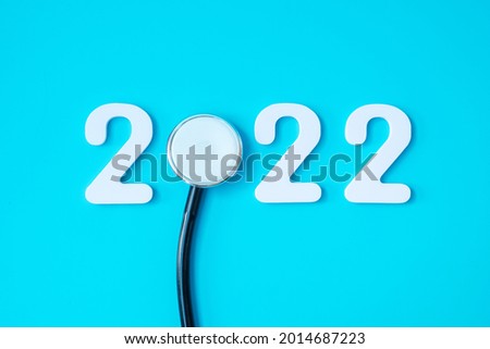 2022 Happy New Year for healthcare, Insurance, Wellness and medical concept. Stethoscope and white number on blue background