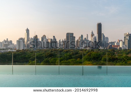 Cityscape and high-rise buildings in metropolis city with water reflection in the early morning .