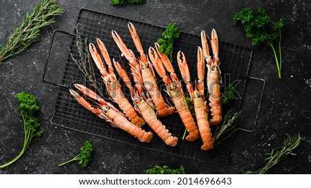 Delicious Grilled Scampi with spices in a black background. Top view. Free copy space.