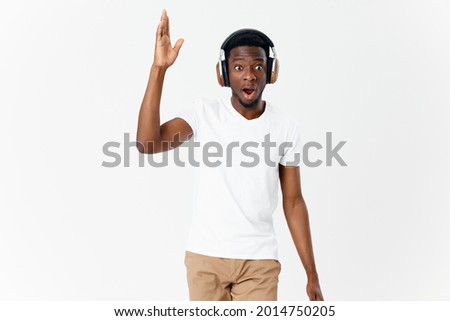 emotional man of african appearance in headphones gesturing with hands lifestyle music lover