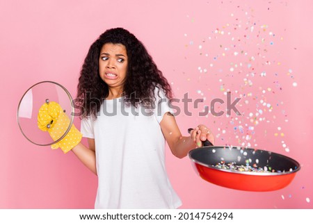 Photo of scared funny dark skin lady wear white t-shirt having burnt dinner isolated pink color background