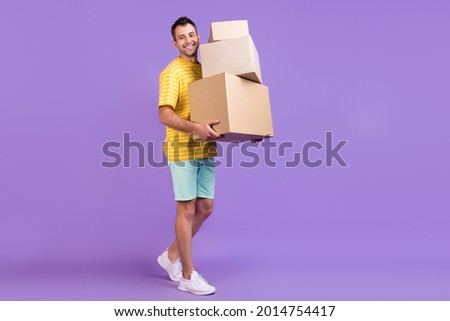 Full body photo of happy cheerful man hold hand boxes smile move houses isolated on purple color background Royalty-Free Stock Photo #2014754417